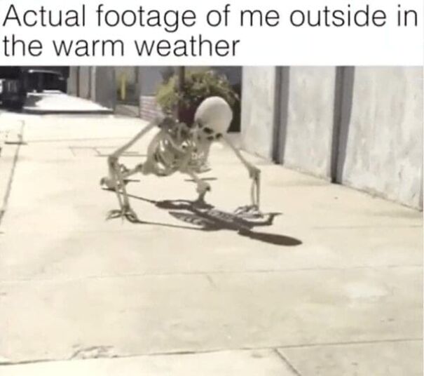 Skeleton crouching on sidewalk in warm weather, illustrating funny summer meme about pretending to enjoy being outside.
