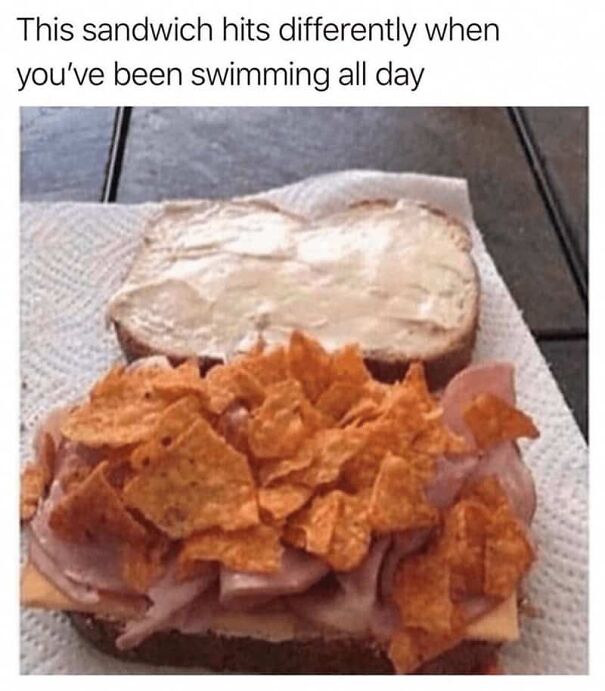 Sandwich topped with chips and ham on a napkin, humorous summer meme about enjoying food after swimming all day.
