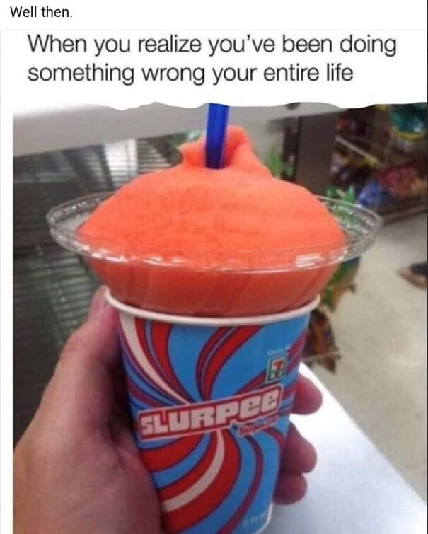 Hand holding a Slurpee with orange ice on top, a funny summer meme about doing something wrong your whole life.