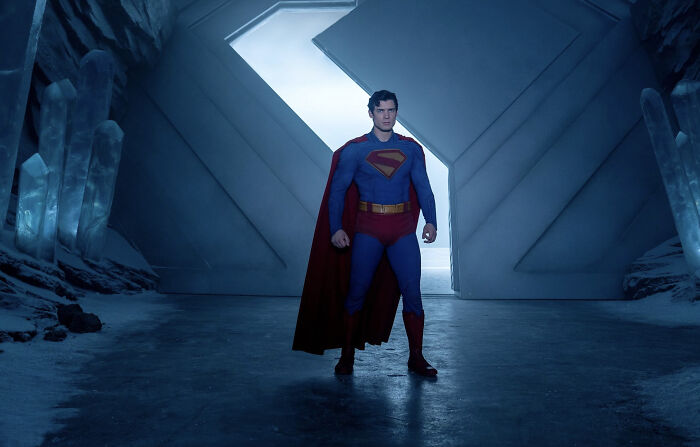 Superman in classic costume standing in an icy fortress scene from the woke Superman reboot receiving harsh early reviews.