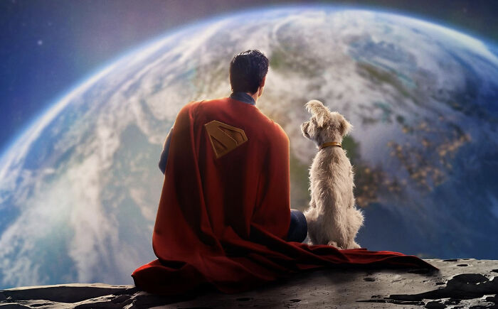 Superman in red cape sitting on moon with dog, overlooking Earth, representing woke Superman reboot in early reviews.