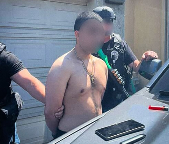Shirtless man in handcuffs being arrested by police officers during an epic police fail incident investigation. - 9