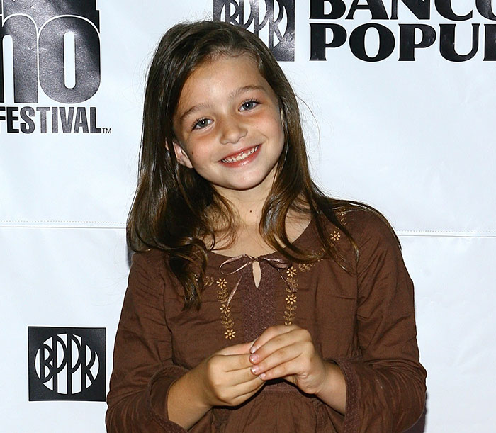Young female star smiling at a festival event, representing stars we've lost this year in July.