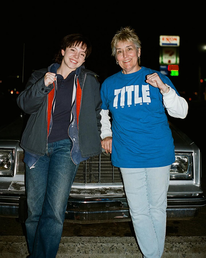 Two women posing by a car at night with fists raised, related to Sydney Sweeney's dramatic body transformation for boxing role. Two women posing by a car at night with fists raised, related to Sydney Sweeney's dramatic body transformation for boxing role.