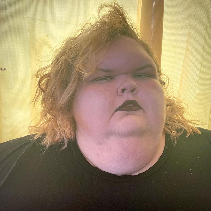 Tammy Slaton from 1000-Lb. Sisters posing indoors with dark lipstick after skin removal surgery results reveal changes.