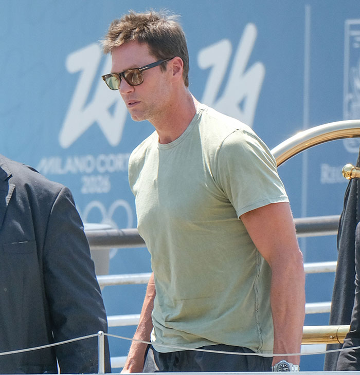 Tom Brady wearing sunglasses and a green shirt during a casual outing amid Sof&iacute;a Vergara summer romance reactions.