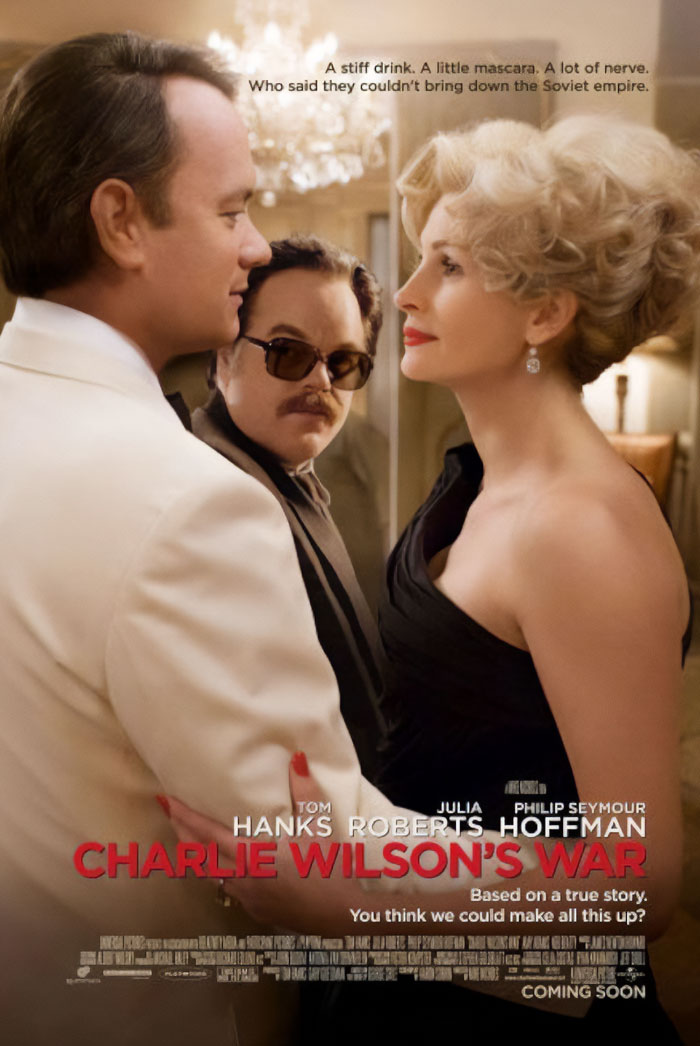 Tom Hanks in a scene from an underrated movie with characters dressed formally in an elegant setting.