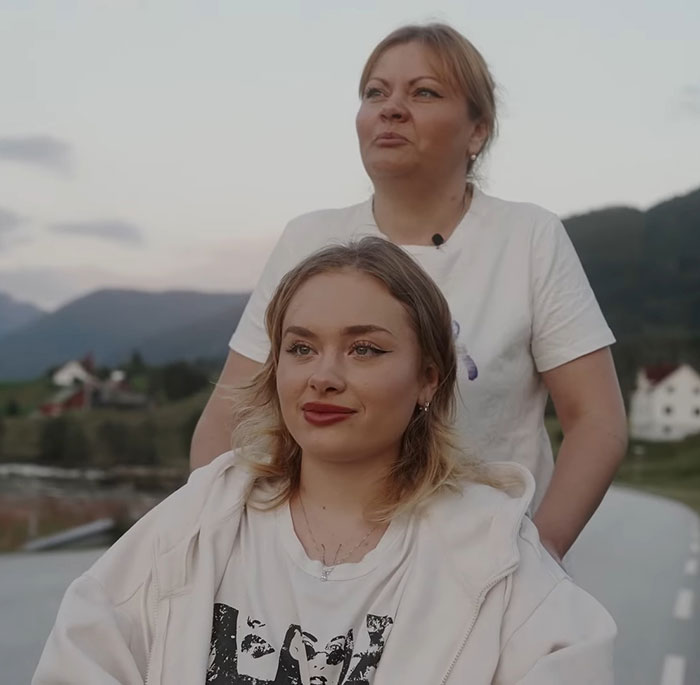 Two women outdoors with scenic background, illustrating a story about a model found with broken limbs and spine. - 11