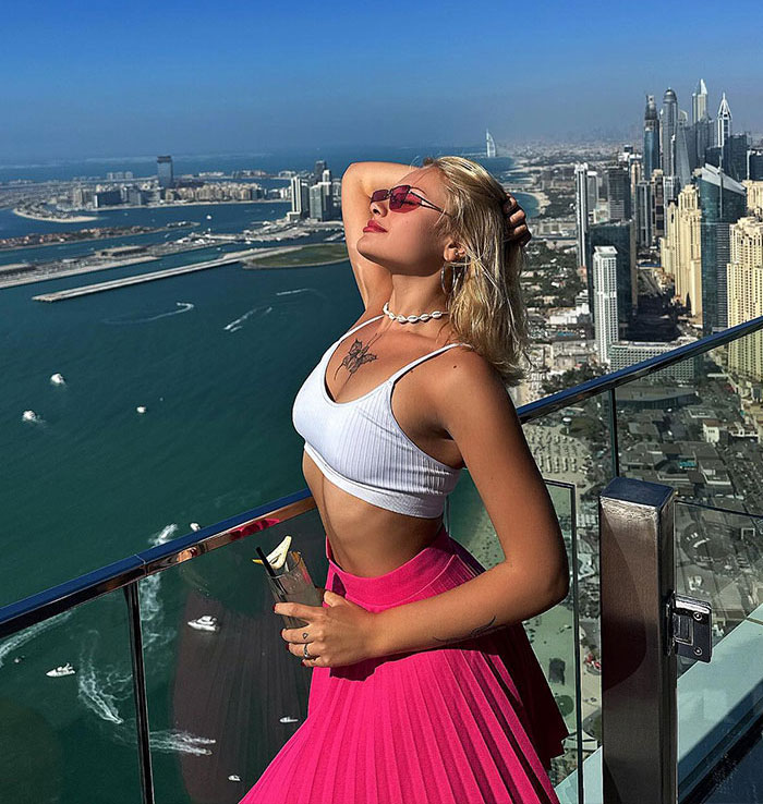 Ukrainian model posing on Dubai rooftop with city skyline and sea view, linked to party before attack on roadside. - 2