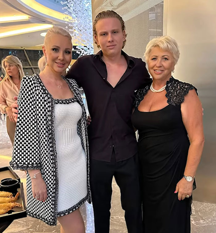 Three people posing indoors, related to Ukrainian model found injured on Dubai roadside before attack. - 9