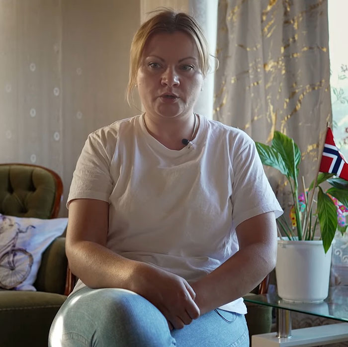 Woman sitting indoors, sharing her story about model found with broken limbs and spine on Dubai roadside. - 9