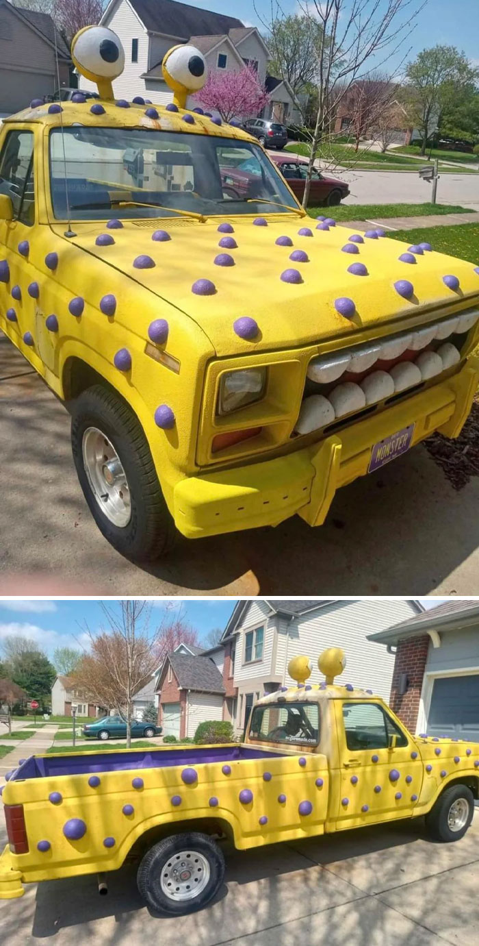 Yellow pickup truck with purple bumps and large eyeball car mods parked in a residential neighborhood.