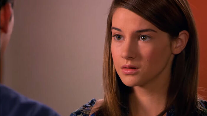 Young woman with brown hair looking concerned in a scene from shows with characters hard to love. - 23