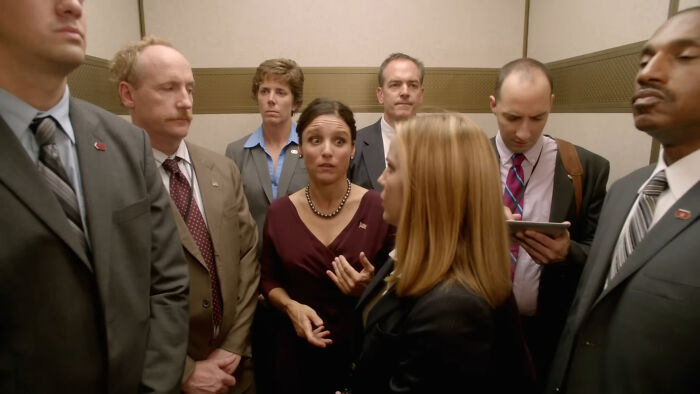 Several characters from popular shows looking tense and uncomfortable in a crowded elevator, highlighting hard to love characters. - 17