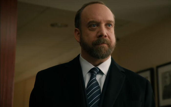 Middle-aged man in a suit with a beard, portraying a difficult character from shows with hard to love characters. - 29
