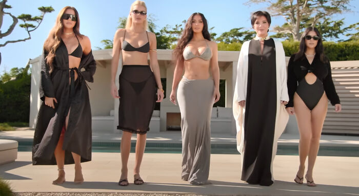 Group of five women standing confidently poolside wearing stylish swimsuits and cover-ups, representing hard to love characters in shows. - 2