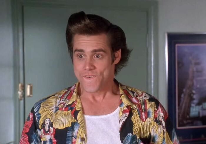 Actor Jim Carrey in a colorful shirt portraying a comedic character in a classic movie scene about celebrities.