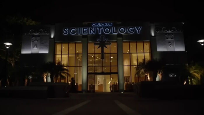 Church of Scientology building at night with illuminated signage, related to pettiest things in breakups discussions.