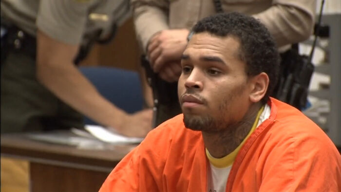 Man in orange prison uniform sitting in courtroom with officers in background, highlighting habits netizens find creepy. - 3