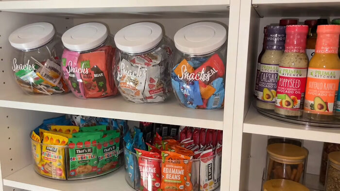 Organized pantry shelves with snacks and sauces illustrating trends leading to overconsumption in everyday products. - 13