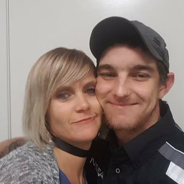 Man in a black cap and woman with blonde hair posing closely, related to vigilante who punished innocent dad case. - 3