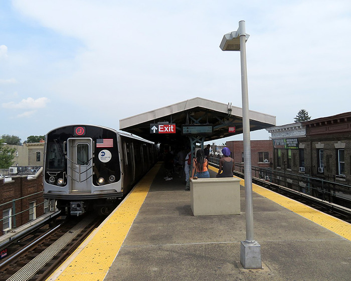Subway platform showing a train arriving with people waiting, related to men delivering vigilante justice after an attack.