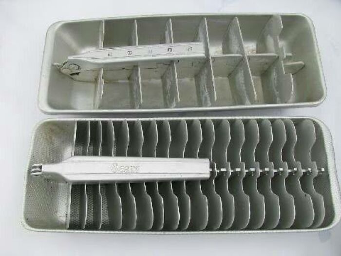Vintage aluminum ice cube trays with a lever mechanism, showcasing unusual and wonderful vintage things design.