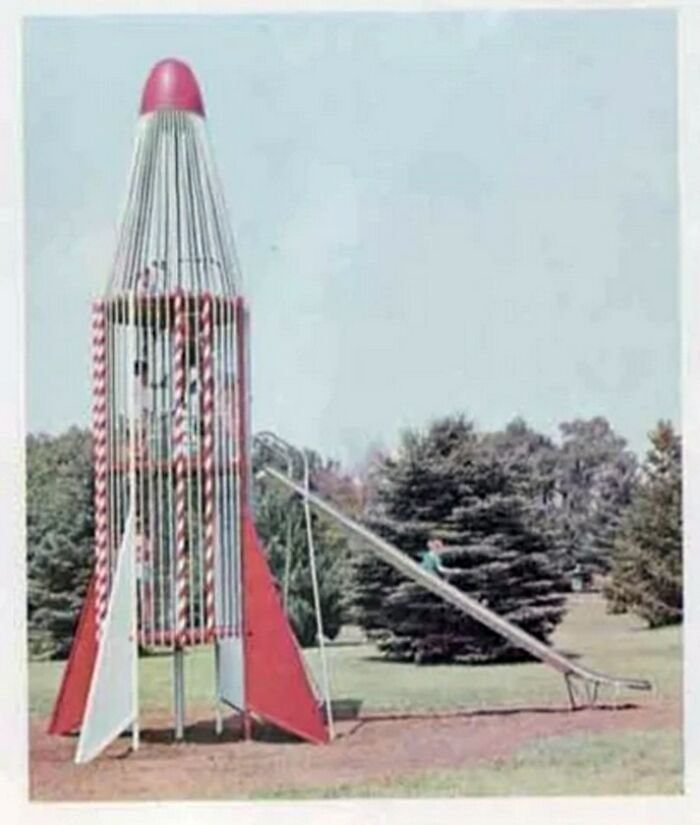 Vintage rocket-shaped playground equipment with slide surrounded by trees, showcasing unique vintage things design.