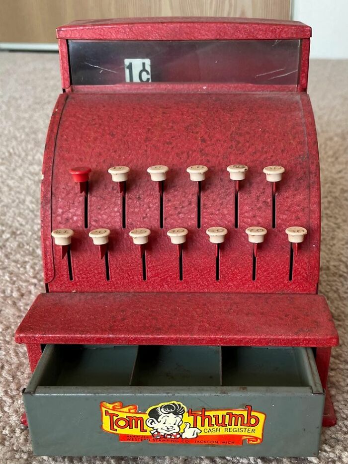 Vintage Tom Thumb toy cash register in red with numbered keys and a 1 cent display, showcasing vintage things collectible charm.
