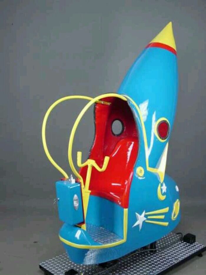 Vintage rocket-shaped kiddie ride in bright blue and red with yellow accents, showcasing a unique vintage thing design.