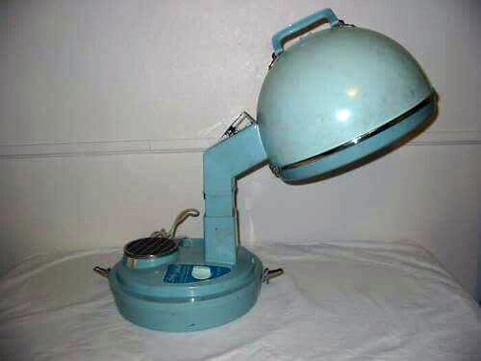 Vintage blue retro hair dryer with dome hood and adjustable arm, a classic example of vintage things collection.