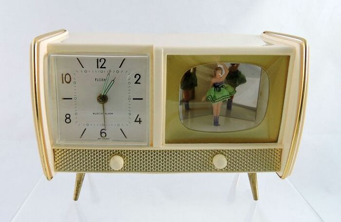 Vintage clock with a dancing figurine display, showcasing weird and wonderful vintage things from past decades.