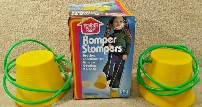 Vintage romper stompers toy with yellow buckets and green cords for balance and coordination development.