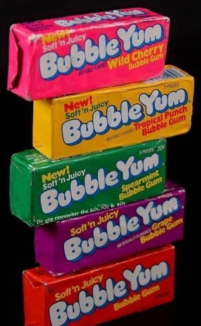 Stack of vintage Bubble Yum bubble gum packages in bright colors showcasing classic flavors from past decades.