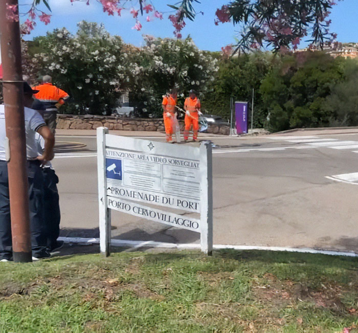 Family of babysitter fatally hit by wife of Lufthansa CEO mourns at roadside near Porto Cervo Villaggio.