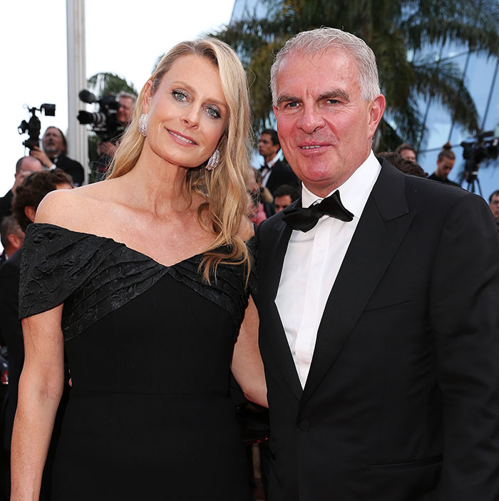 Couple dressed formally at an event, representing family of babysitter fatally hit by wife of Lufthansa CEO.