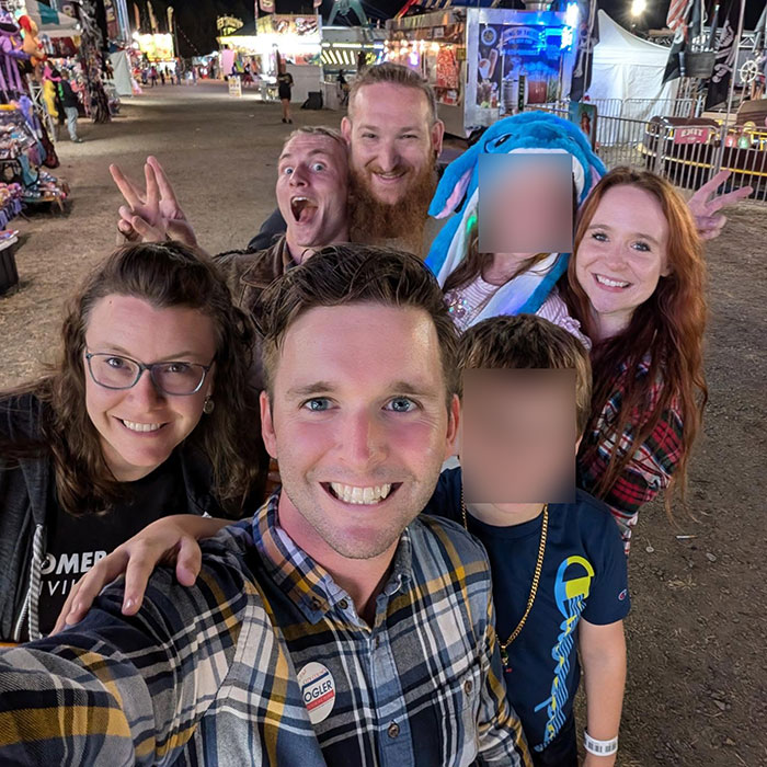 Group selfie showing smiling people at an outdoor event, unrelated to Virginia councilman set on fire incident.