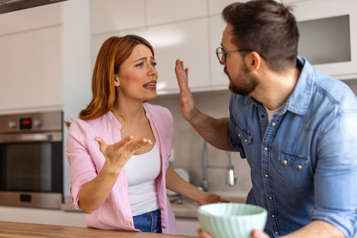Woman begs friend to cut off guy during petty conflict, tense moment captured in modern kitchen setting.