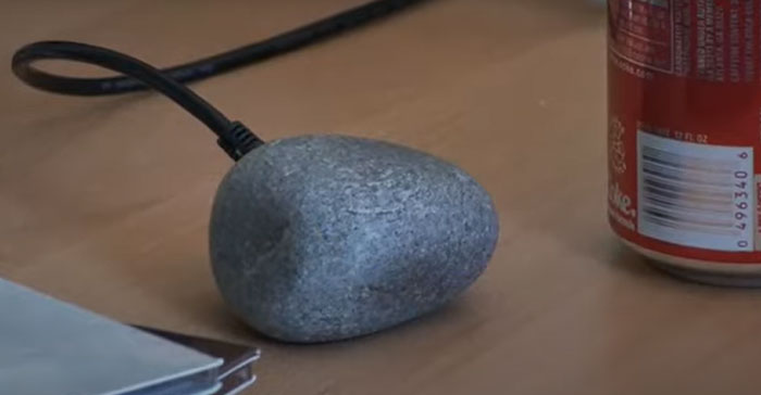 Unusual electronic device shaped like a rock connected by a cable, showcasing one of the weird inventions the world wasn’t prepared for.