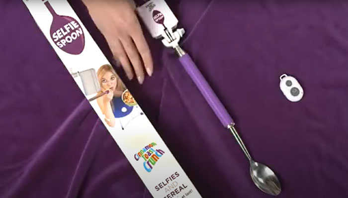 Selfie spoon with remote control and packaging, demonstrating weird inventions the world just wasn’t prepared for.