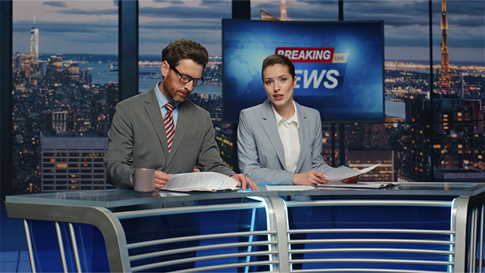 Two news anchors in a studio discussing things non-Americans find weird about the US that locals see as normal. - 8