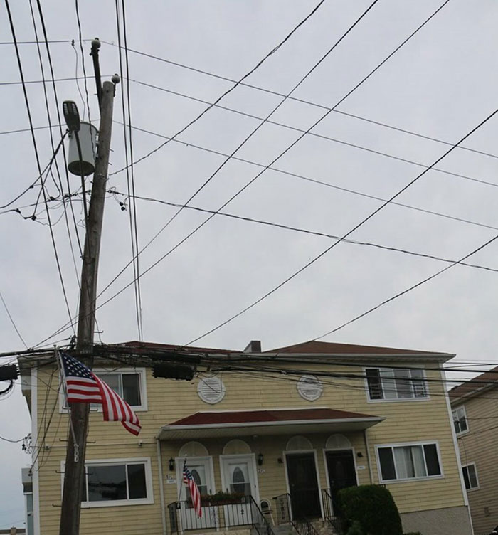 American residential house with multiple utility wires and flags showing common US oddities seen by non-Americans - 39