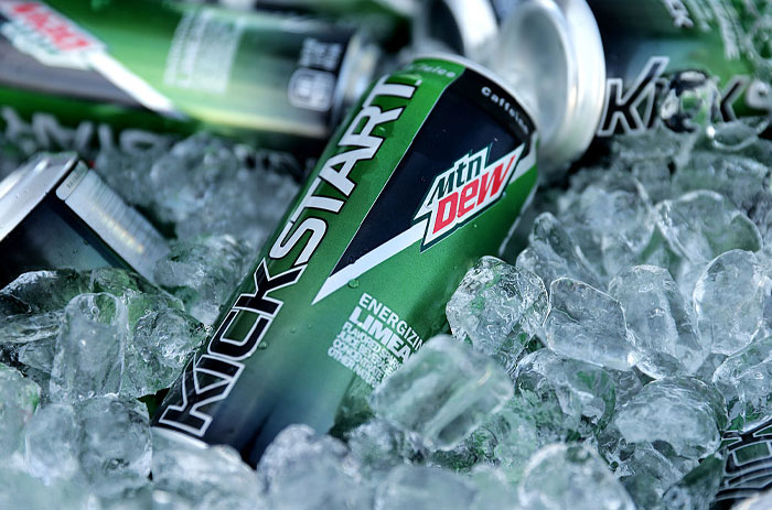 Cans of Mountain Dew Kickstart energy drink on ice representing American foods banned in other countries.