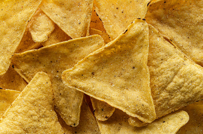 Close-up of American tortilla chips, an example of American foods banned in other countries due to ingredient regulations.