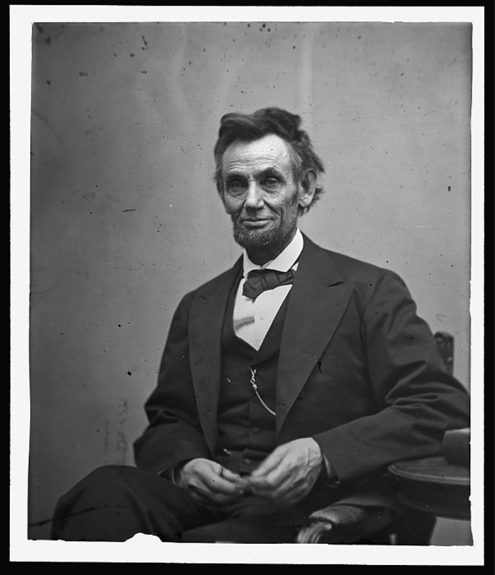 Portrait of Abraham Lincoln seated in a suit, representing US presidents with the highest IQ rankings.