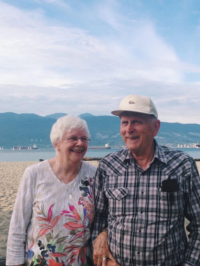 Elderly couple smiling at the beach, embodying wholesome people that make the world a better place.