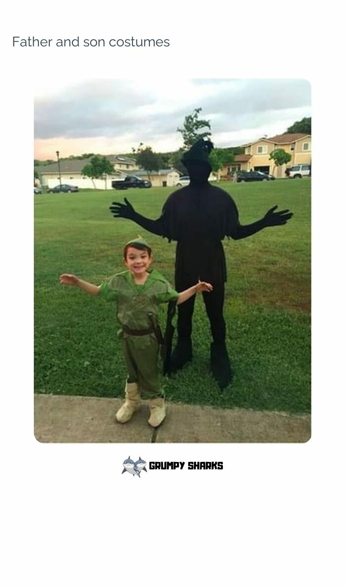 Father and son in wholesome costumes posing outdoors in a neighborhood park, spreading joy and making the world better.