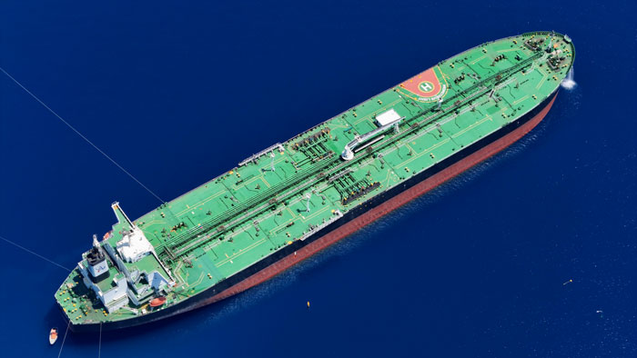 A large cargo ship sailing in deep blue sea, illustrating fears a husband is lost at sea. A large cargo ship sailing in deep blue sea, illustrating fears a husband is lost at sea.