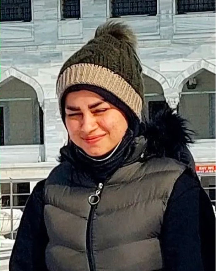 Young woman wearing a winter hat and jacket, linked to resurfaced case of 17YO mom brutally assassinated by husband.