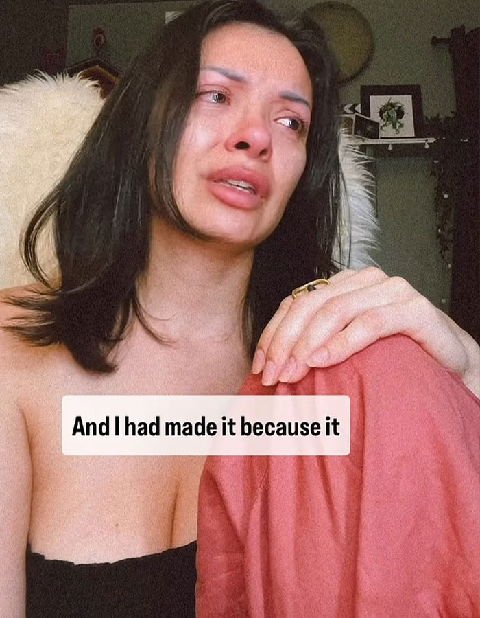 Woman with dark hair and red lips looks distressed discussing her $6,640 nose job that ruined her face.